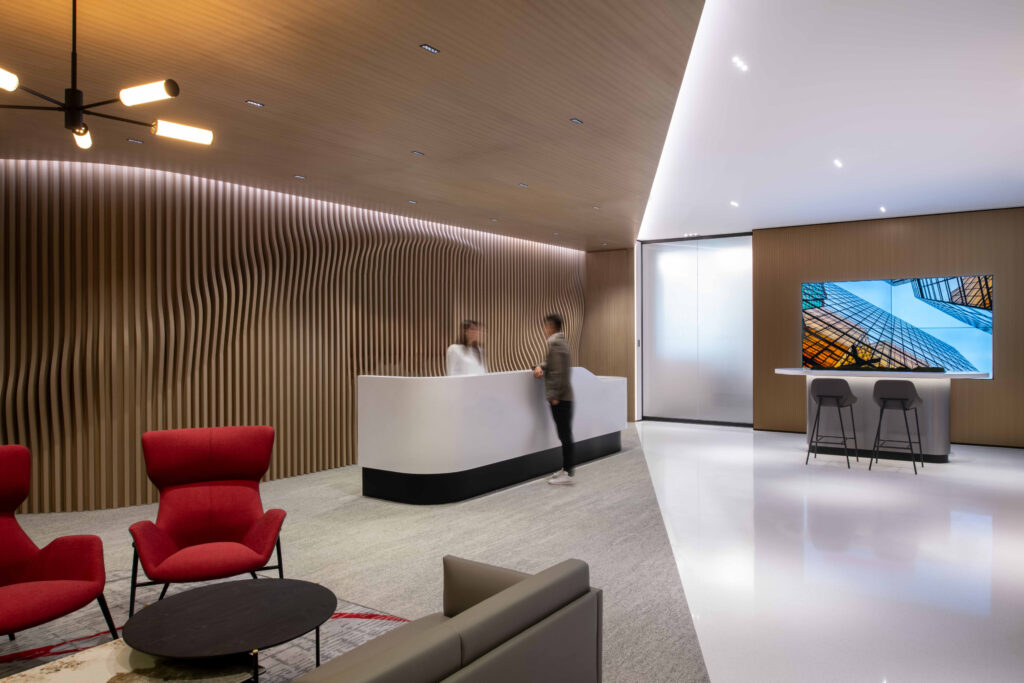 Upon entering the reception, visitors are greeted with a striking, sculpted timber mural wall, exuding confidence and reflecting the bank's commitment to innovation and approachability.
